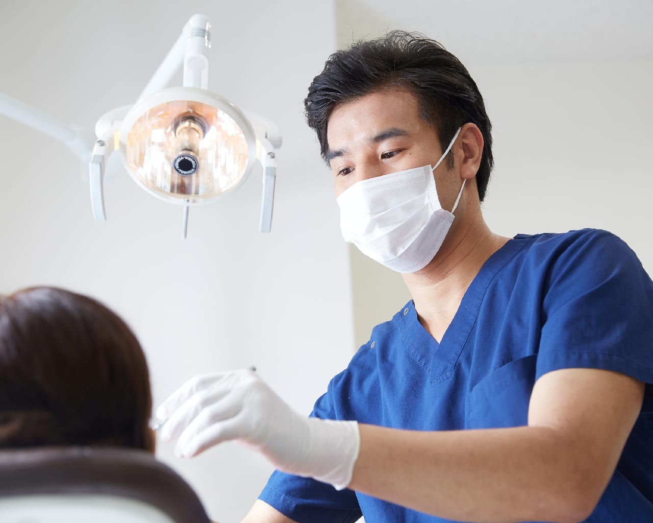 Dentist performing wisdom tooth surgery & extraction