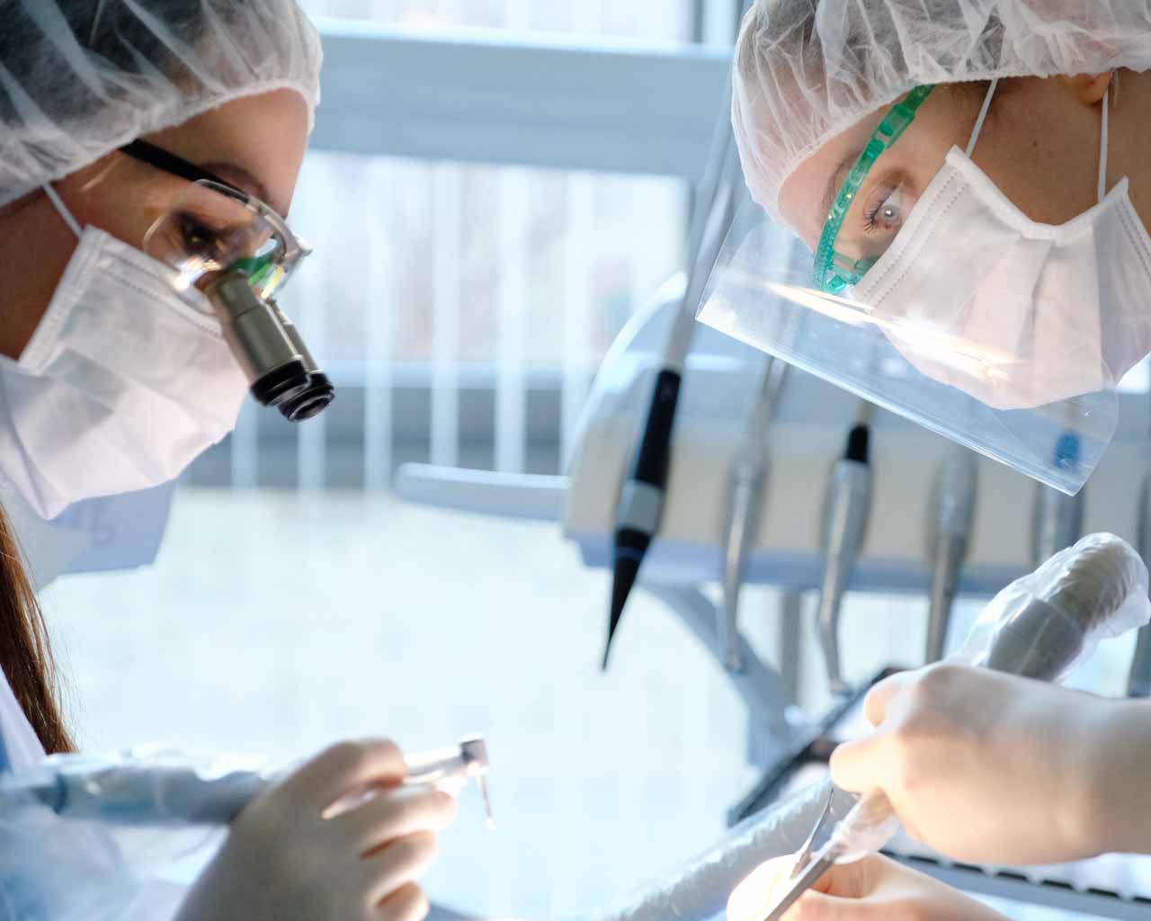 dental implant placement Dental Surgeons placing Dental Implant at NoFrills Dental