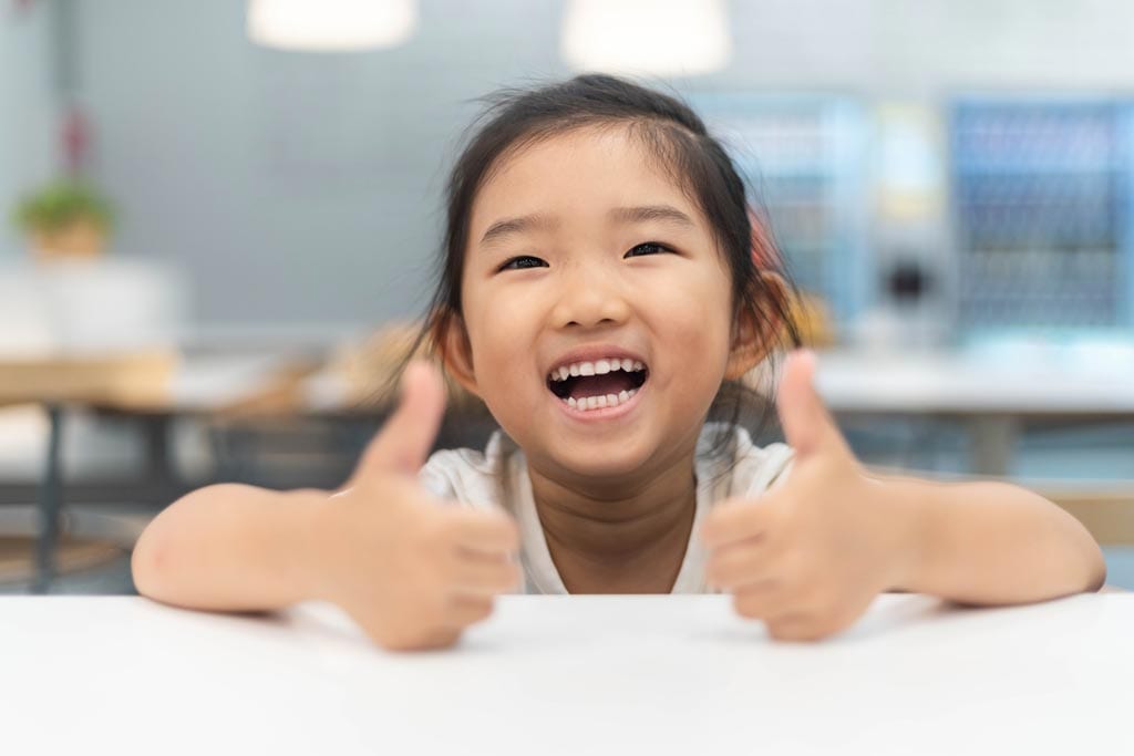 happy little girl undergoing Invisalign first treatment