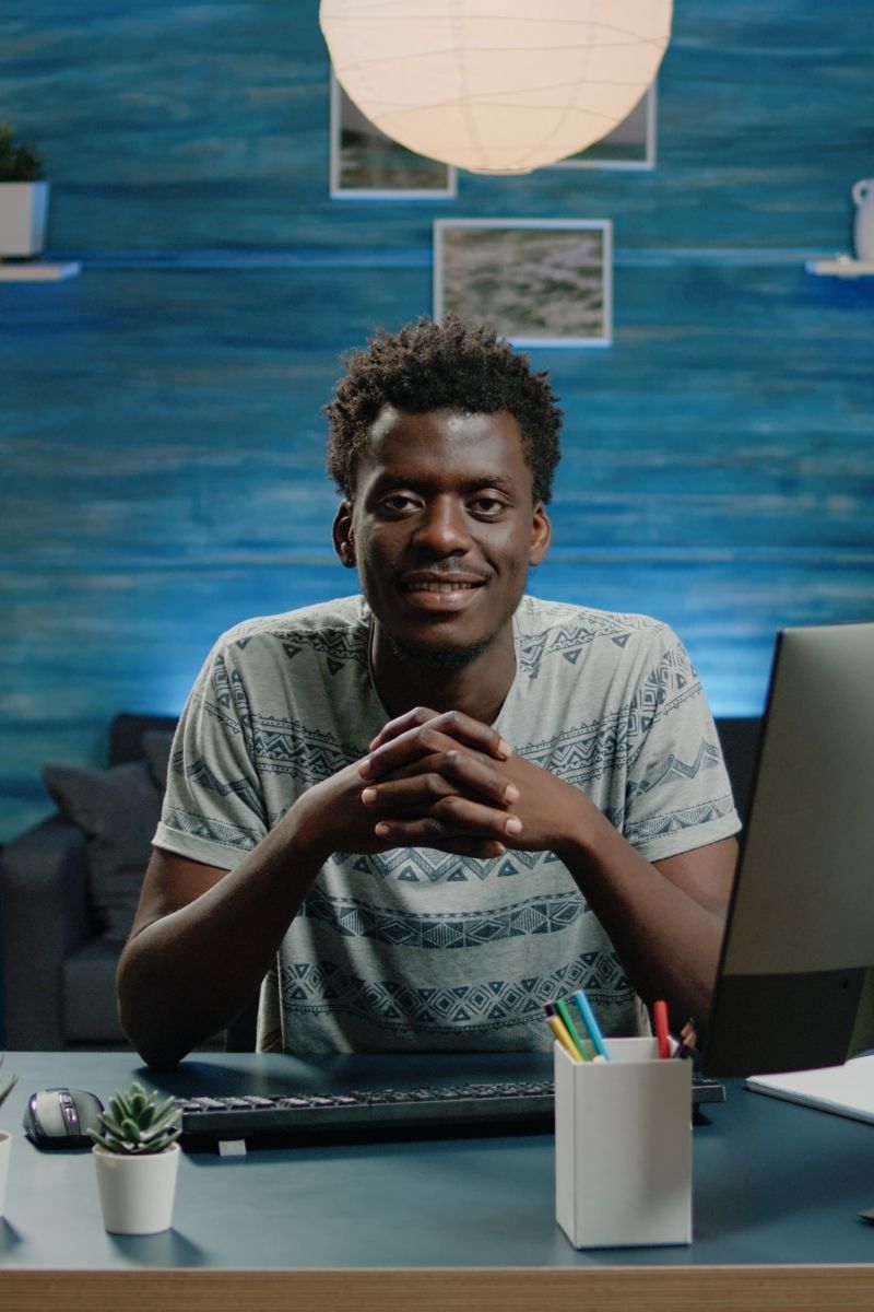 adult sitting behind a table adult sitting behind a table