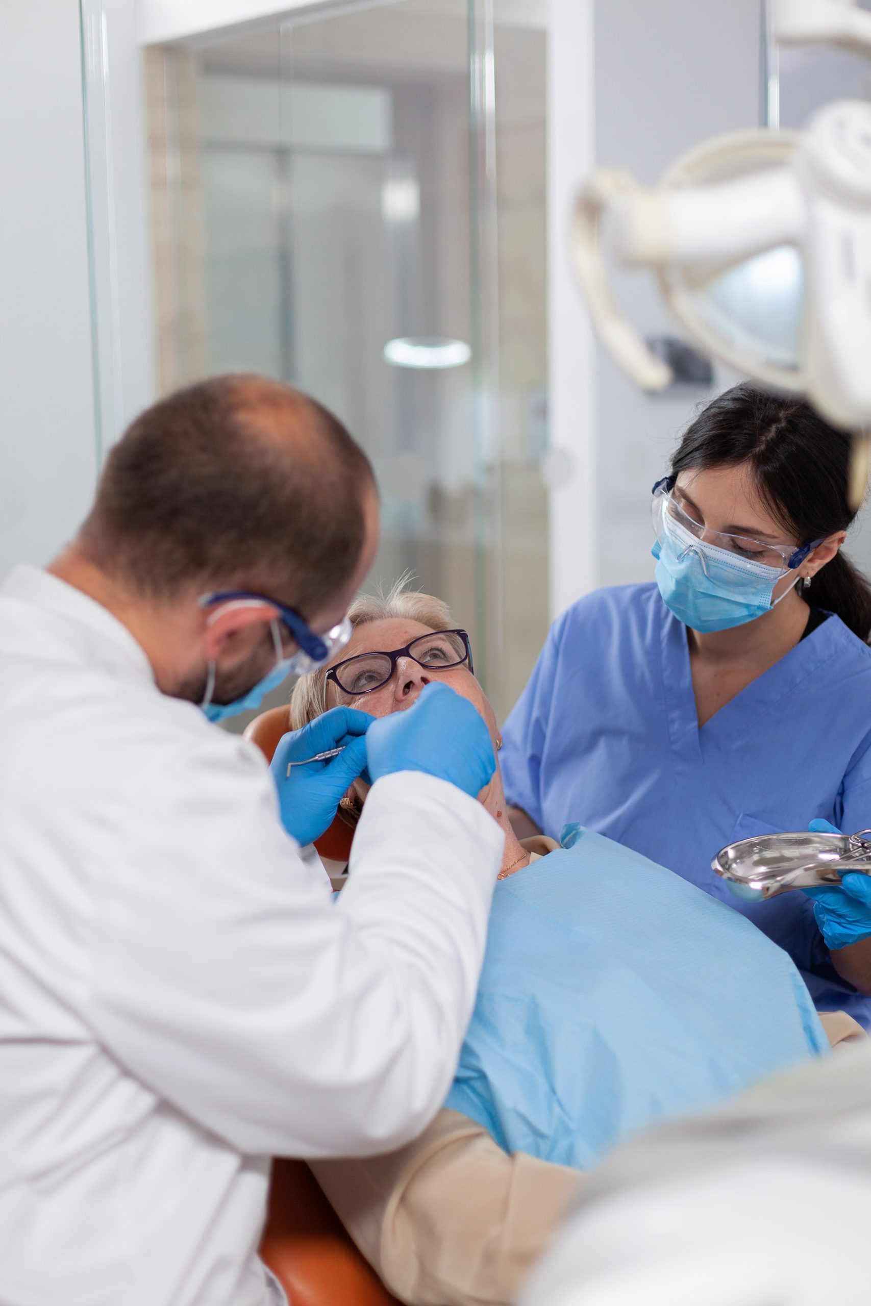 dentist performing implant procedure dentist performing implant procedure